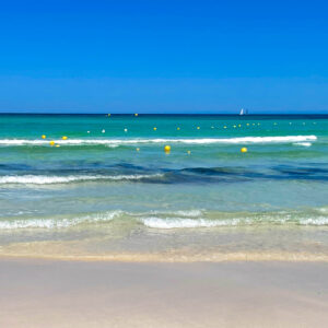 Serene Turquoise Waters and Sandy Shores with Buoys