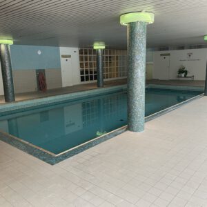 Hallenbad mit beleuchteter Natursteinwand